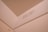 An interior corner of a room features a beige wall with a visible weight capacity indication marked 'MAX CAP - 1200 LBS -'. The surface appears smooth and painted, with lighting giving it a warm hue.