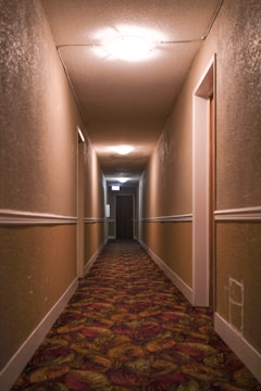 Bright hallway with beige walls and white trim, showcasing smooth paint application.