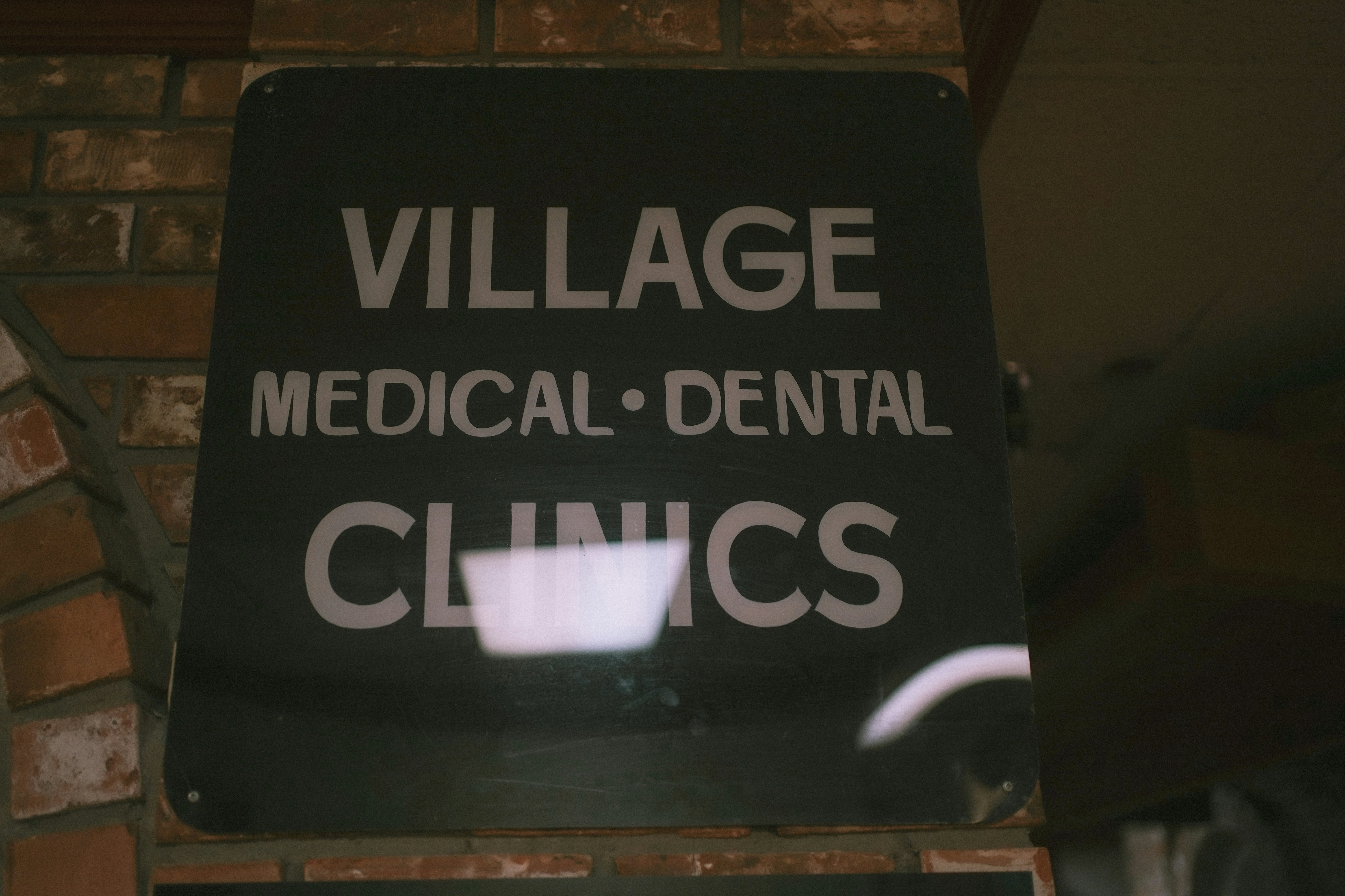 a black and white sign that says village medical dental clinic
