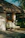 A serene outdoor massage setup surrounded by greenery and soft natural light.