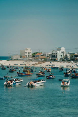 Colorful fishing boats bobbing gently in the turquoise waters of a coastal village.