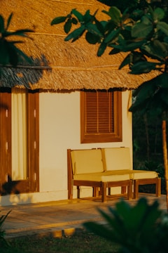 A cozy backyard with a custom blue-colored wooden canopy providing shade and comfort.