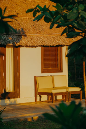 A cozy garden setup featuring a minimalist shade canopy over a wooden seating area.