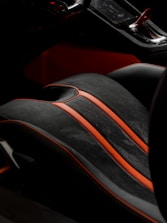 Close-up of custom red and black seat covers fitted inside a modern car.
