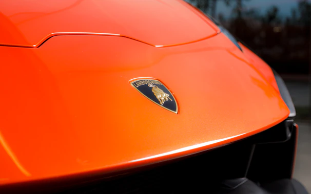 Close-up of a gleaming sports car hood freshly polished by El Toros Detail in Orange County.