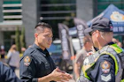 A police officer sharing real-world experiences with aspiring cadets.