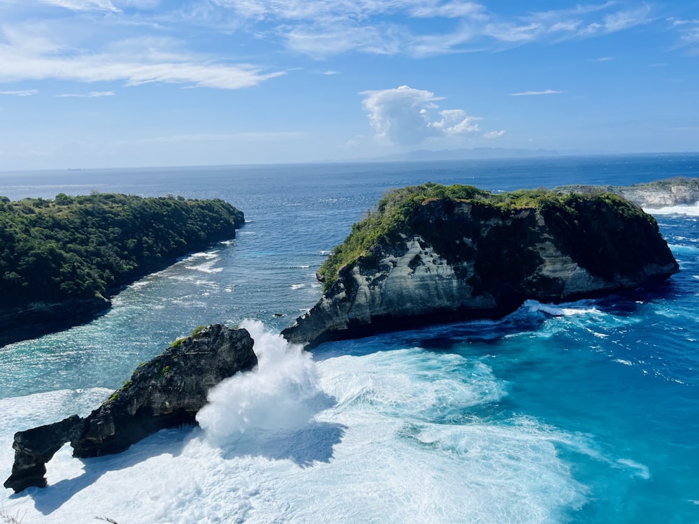 an aerial view of the ocean and a rock formation