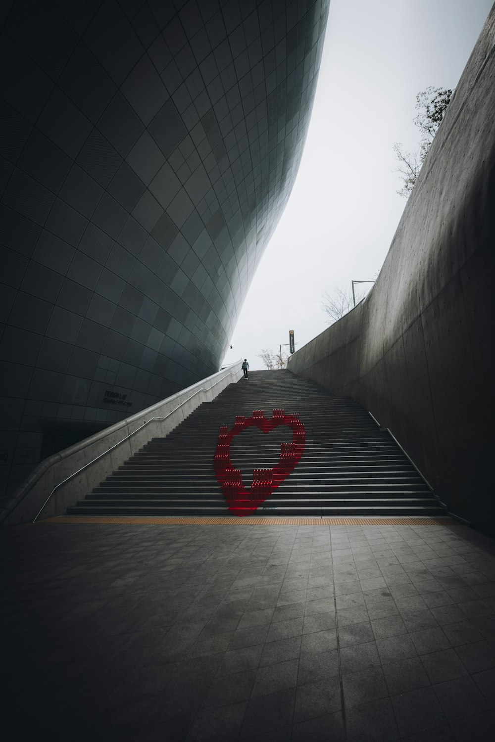 a heart shaped object sitting on top of a set of stairs