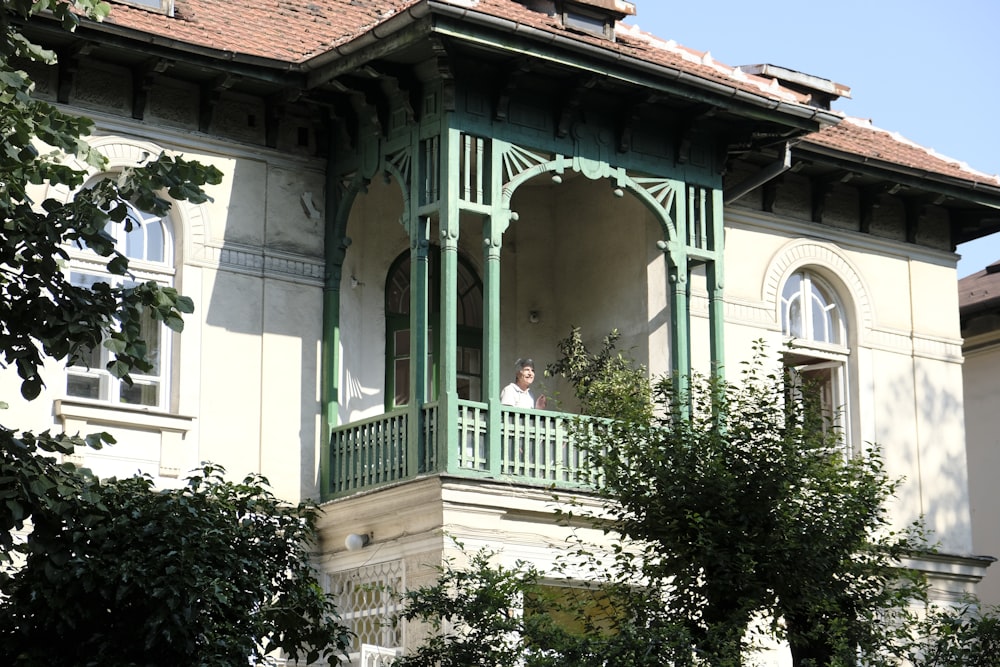 a man standing on a balcony of a house