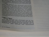 A close-up image of an open book displaying text in English. The page on the left contains paragraphs of printed text with a heading titled 'Flight to Egypt'. The page on the right is mostly empty with rows of dotted lines meant for writing.