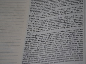 A close-up view of a page from a book with text printed in two columns. The text is clear and in English, featuring both narrative and dialogues. There are dotted lines on the left side of the page, possibly for writing notes.