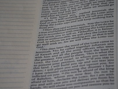 A close-up view of a page from a book with text printed in two columns. The text is clear and in English, featuring both narrative and dialogues. There are dotted lines on the left side of the page, possibly for writing notes.