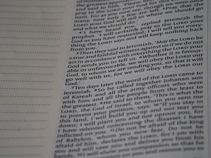 A close-up view of a page from a book with text printed in two columns. The text is clear and in English, featuring both narrative and dialogues. There are dotted lines on the left side of the page, possibly for writing notes.