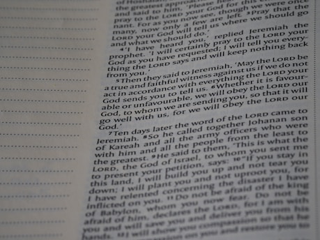 A close-up view of a page from a book with text printed in two columns. The text is clear and in English, featuring both narrative and dialogues. There are dotted lines on the left side of the page, possibly for writing notes.