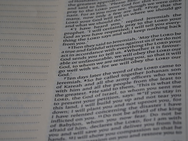 A close-up view of a page from a book with text printed in two columns. The text is clear and in English, featuring both narrative and dialogues. There are dotted lines on the left side of the page, possibly for writing notes.