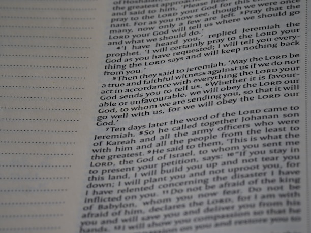 A close-up view of a page from a book with text printed in two columns. The text is clear and in English, featuring both narrative and dialogues. There are dotted lines on the left side of the page, possibly for writing notes.