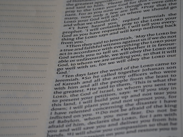 A close-up view of a page from a book with text printed in two columns. The text is clear and in English, featuring both narrative and dialogues. There are dotted lines on the left side of the page, possibly for writing notes.