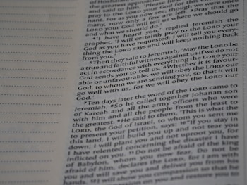 A close-up view of a page from a book with text printed in two columns. The text is clear and in English, featuring both narrative and dialogues. There are dotted lines on the left side of the page, possibly for writing notes.
