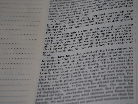 A close-up view of a page from a book with text printed in two columns. The text is clear and in English, featuring both narrative and dialogues. There are dotted lines on the left side of the page, possibly for writing notes.