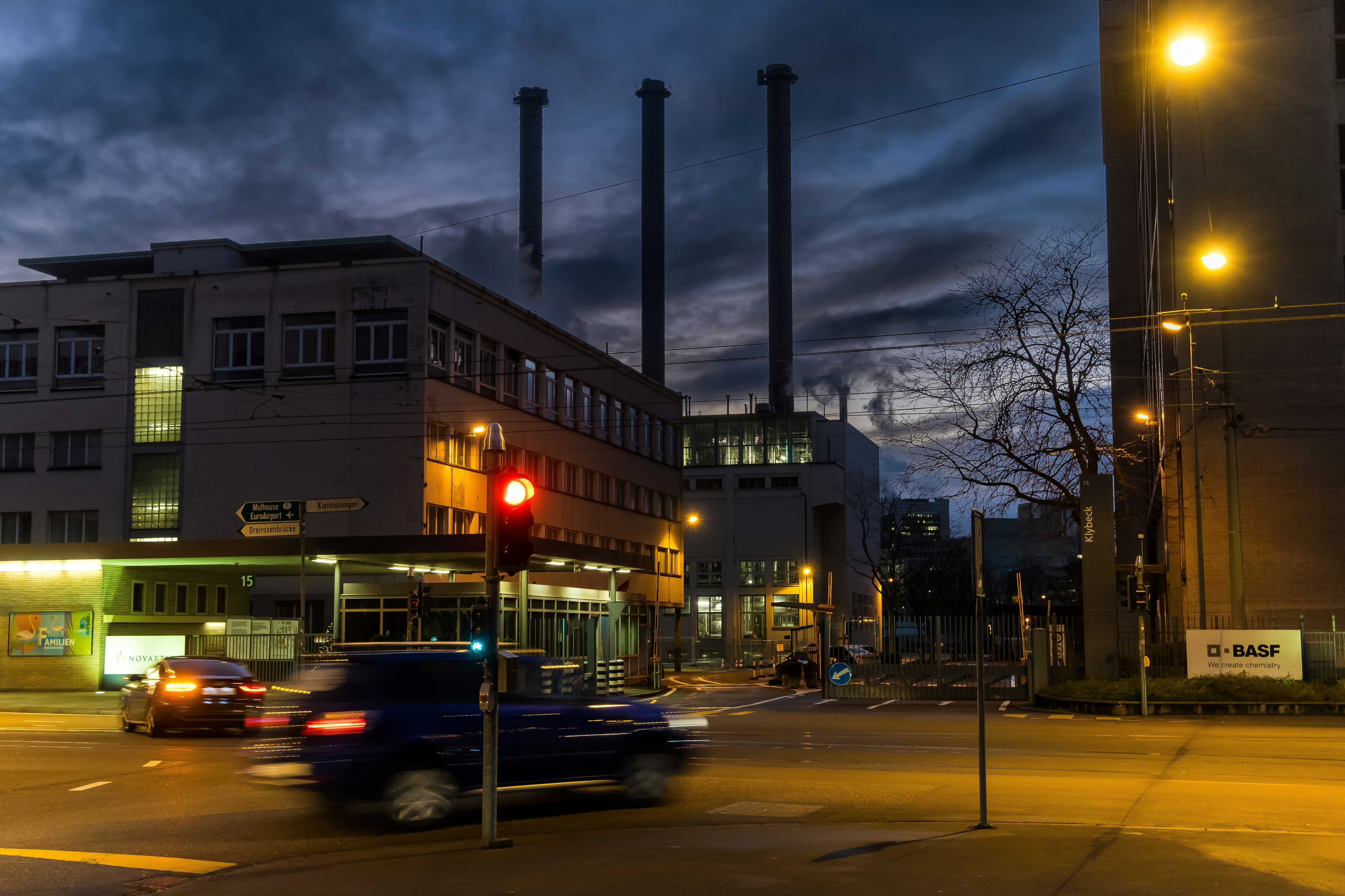 A city street at night with a red traffic light photo Free Basel