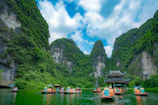 Tourists enjoying a serene boat ride along the Thu Bon River near Hoi An.