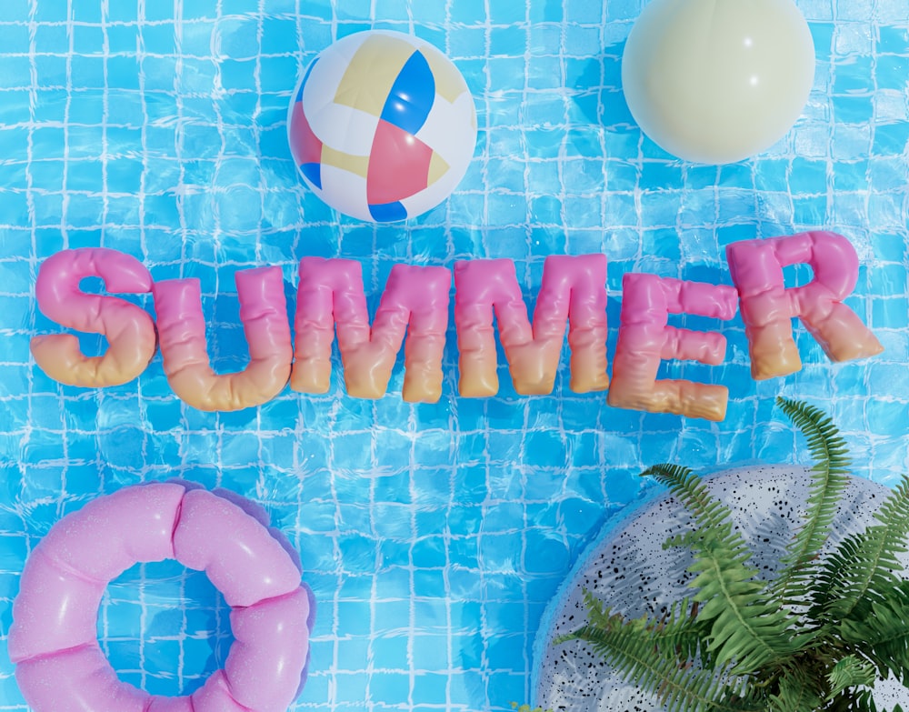 a pool with a pool float, inflatable toys, and the word summer