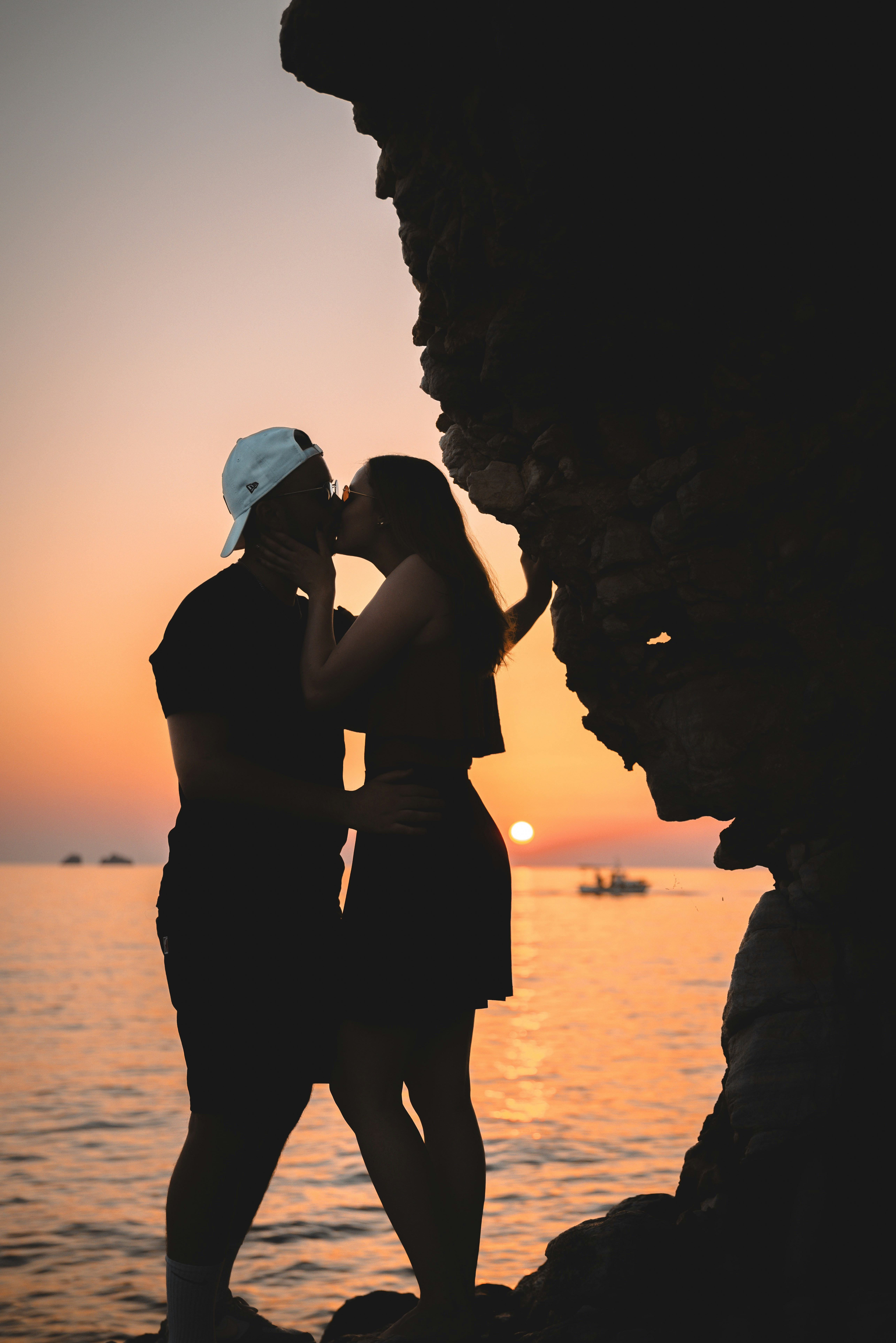 a couple of women standing next to each other near the ocean