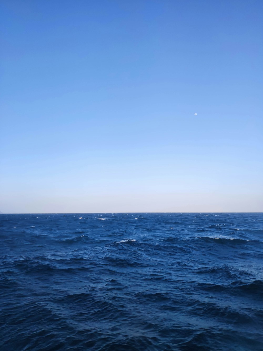 a large body of water with a sky background