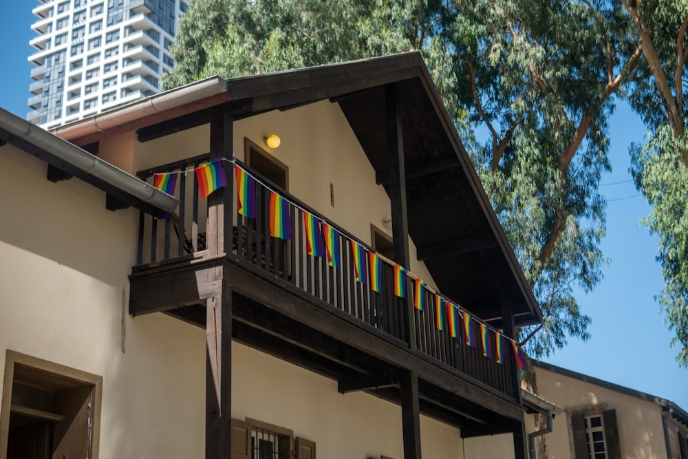 a building with a balcony and a rainbow flag on it