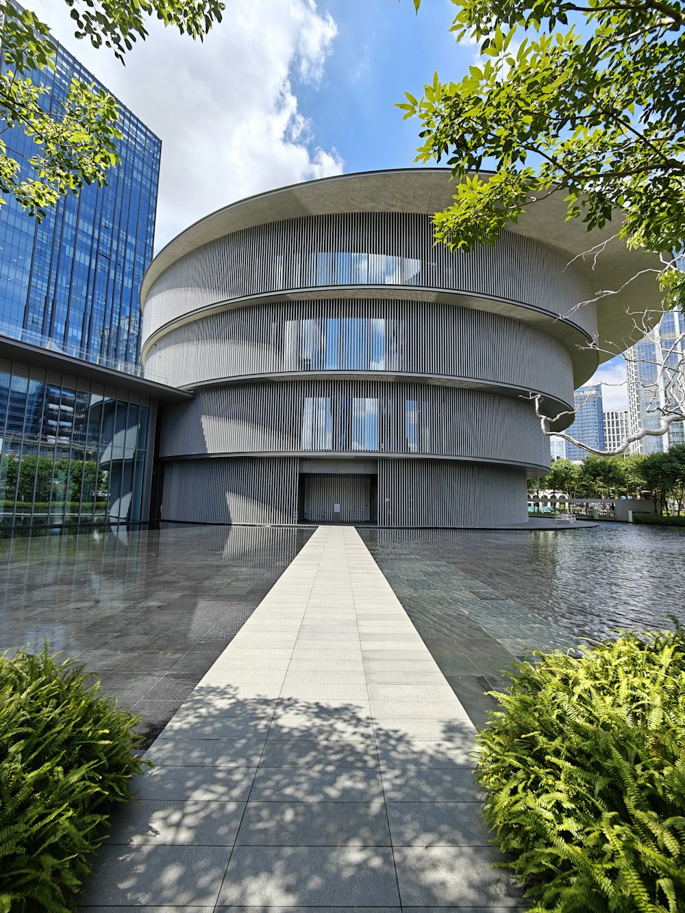 a circular building with a walkway in front of it