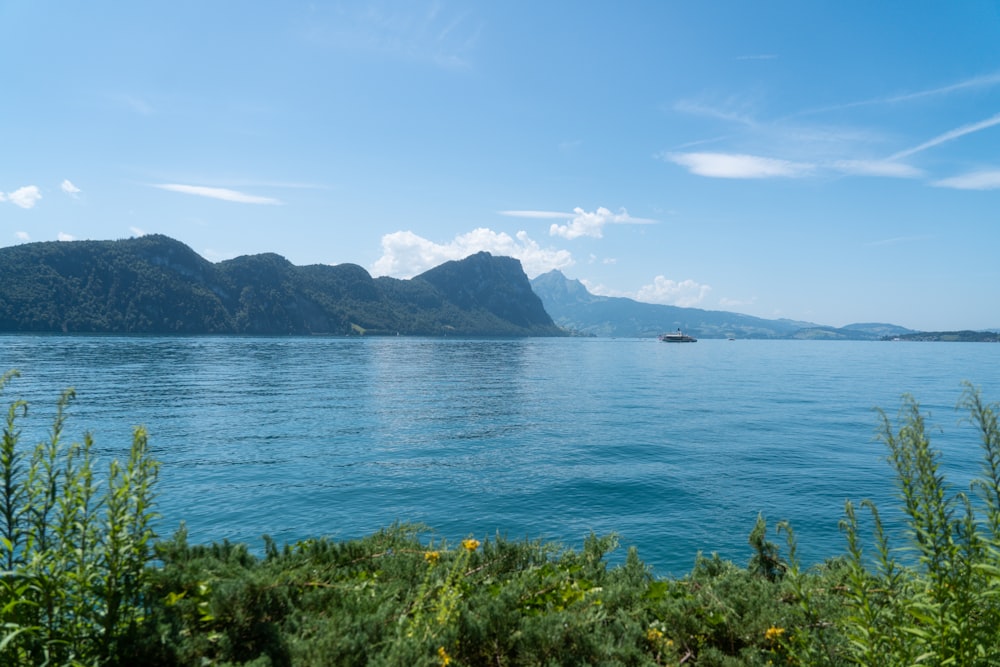 a large body of water with mountains in the background