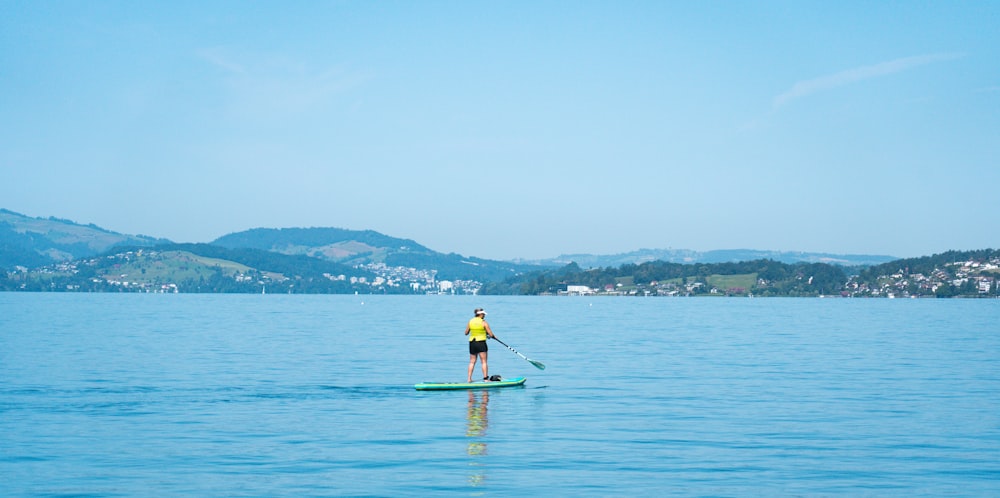 a person riding a paddle board on a large body of water