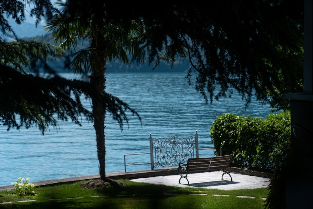 a park bench sitting next to a body of water