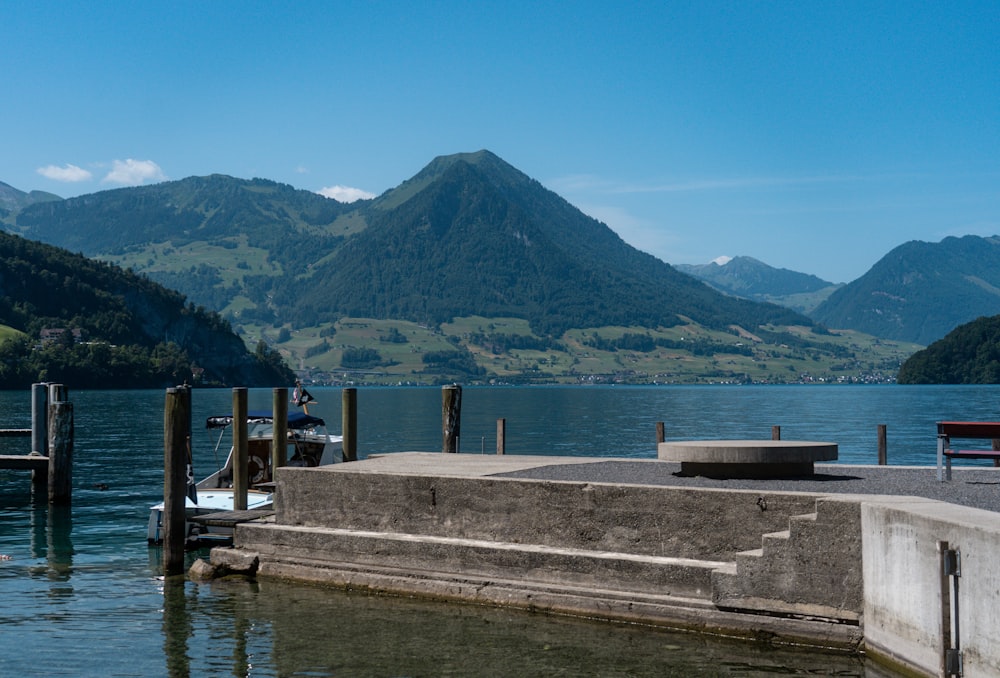 a dock on a lake with mountains in the background