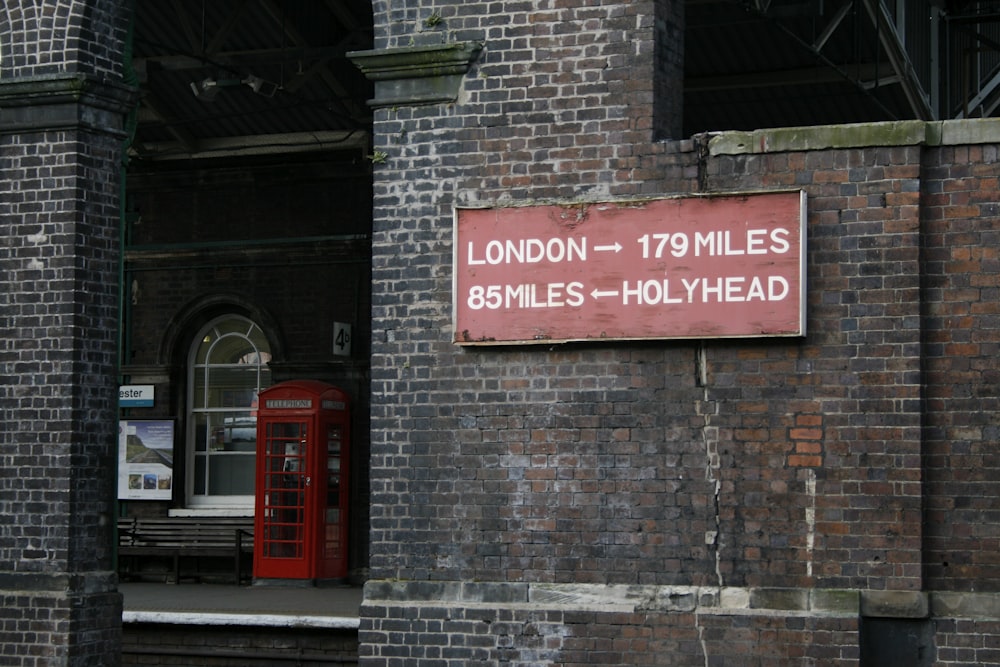 a sign on the side of a brick building