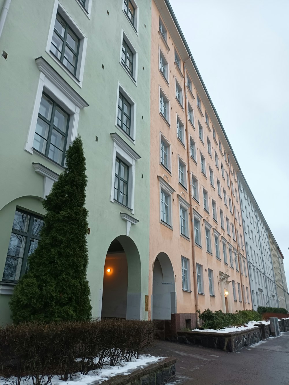 a large building with a lot of windows next to a street