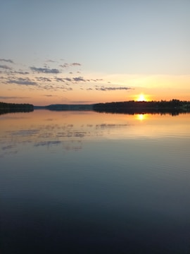 A vibrant sunset over a calm lake reflecting colorful skies.