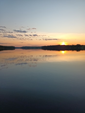 A vibrant sunset over a calm lake reflecting the colors of the sky.