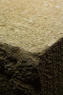 Close-up of a raw Polish flint stone with earthy textures and natural patterns.
