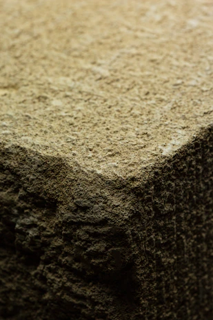 Close-up of a raw Polish flint stone with earthy textures and natural patterns.