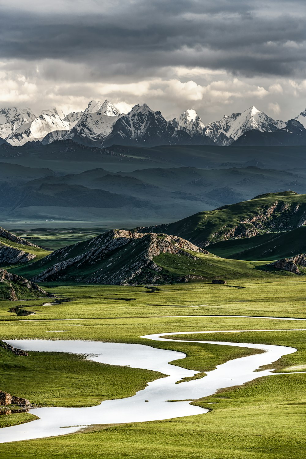 a river running through a lush green valley