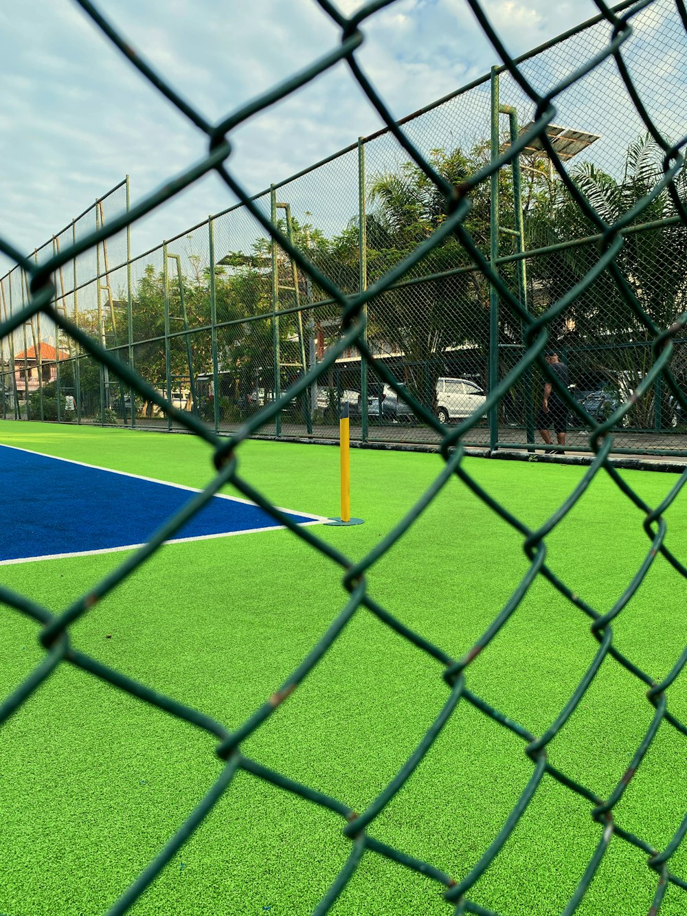 a baseball field behind a chain link fence