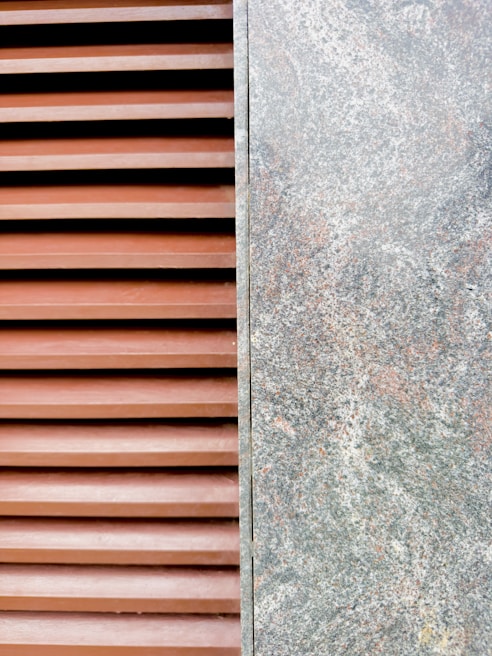 Close-up of textured stone alternative cladding combined with smooth chipboard surfaces