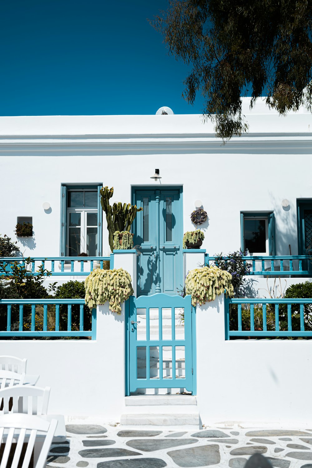 a white house with blue doors and windows