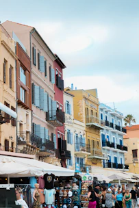 A lively street scene in Tirana with colorful buildings and locals walking.