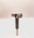A metal tool with a cylindrical handle and a sharp, angular cutting head is positioned vertically against a plain, light background. The tool appears to be designed for precision cutting or boring tasks.