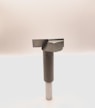 A metal tool with a cylindrical handle and a sharp, angular cutting head is positioned vertically against a plain, light background. The tool appears to be designed for precision cutting or boring tasks.