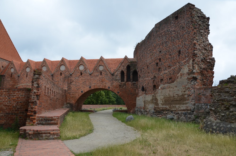 an old brick building with a walkway leading to it