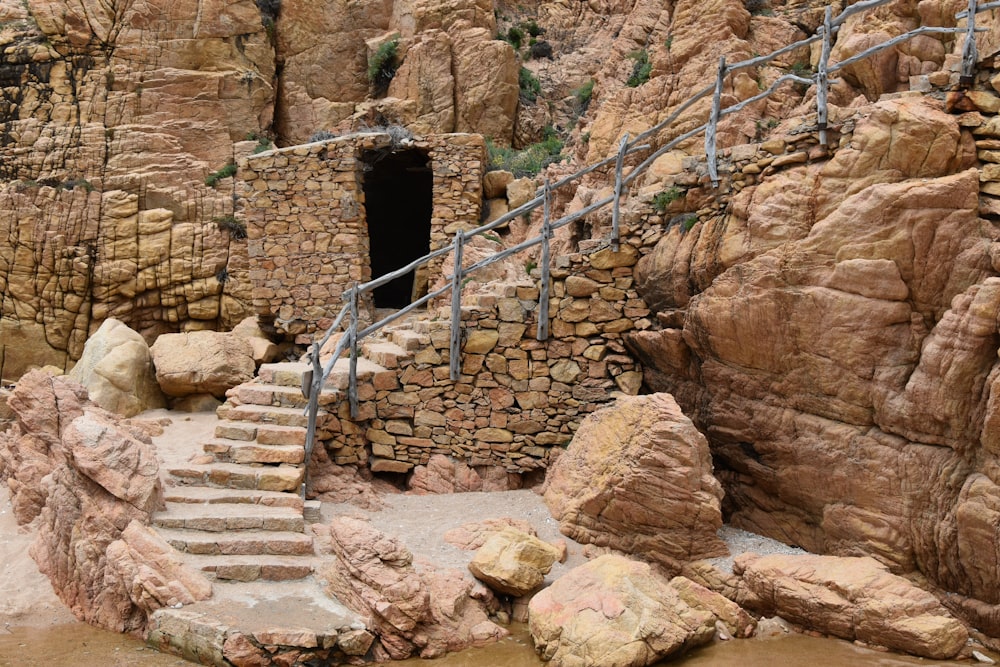 a set of stairs leading up to a cave