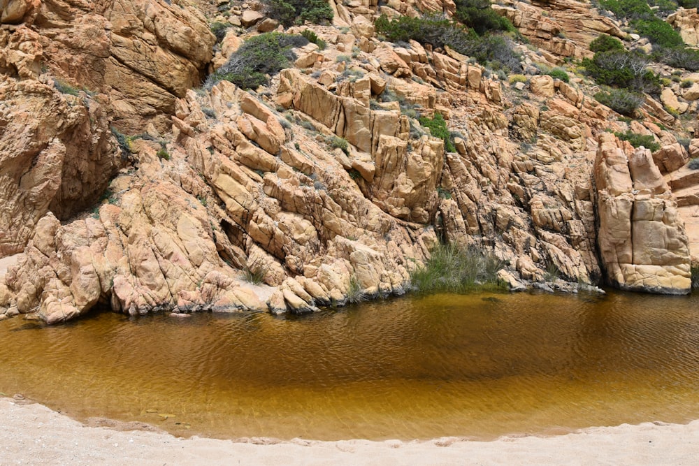 a body of water surrounded by large rocks